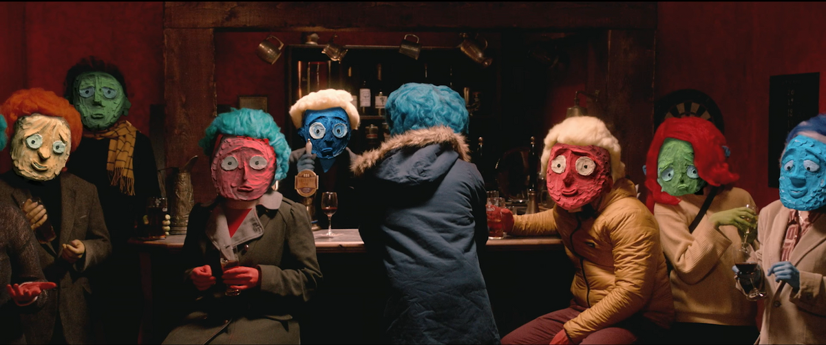 Still from the short film: A group of people with claymation faces sit at a bar staring down the camera at the viewer